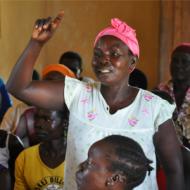 Woman standing up and raising hand