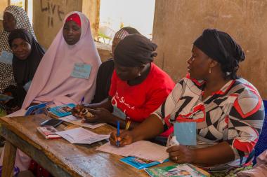 women taking notes in program