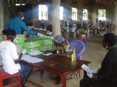 Women for Women International staff distribute soap and stipends to participants in Yei, South Sudan.