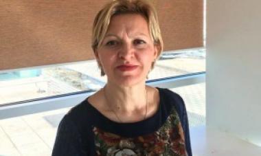 woman in black shirt in front of window